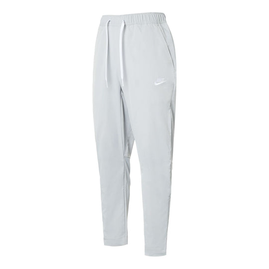 Nike Club Men's Woven Tapered Leg Pants.